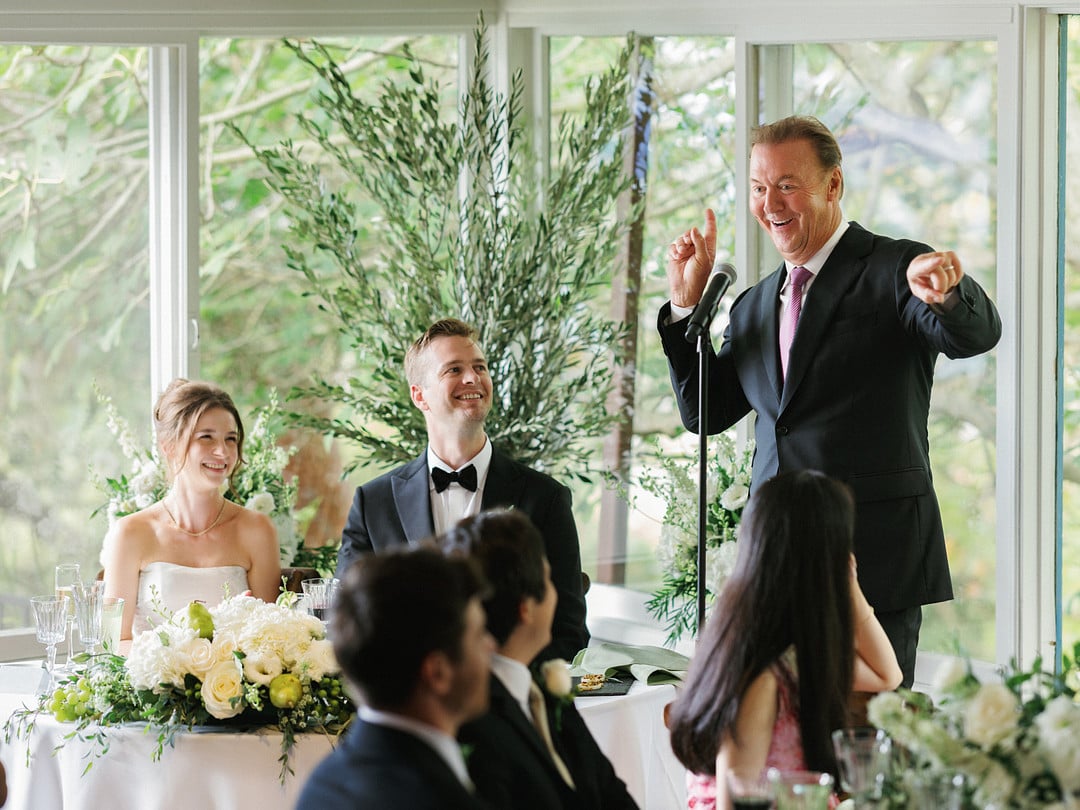 Baylee and Avery laughing during toasts at their La Venta Inn reception