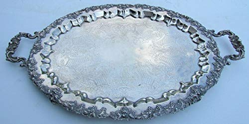 An ornate antique-style silver-plated serving tray with grape design