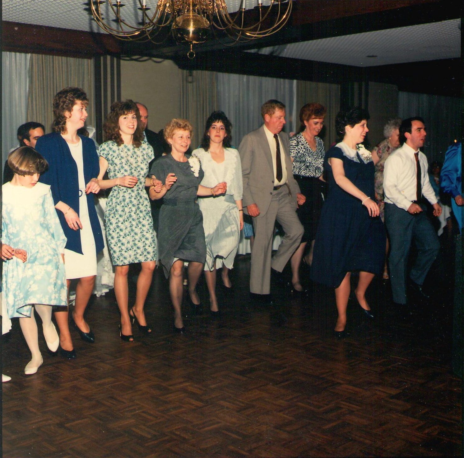 Guests in a dance line across the hall at a 1988 wedding reception