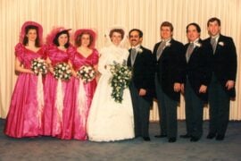 1988 wedding party: bride and groom with bridesmaids in hot-pink satin puff-sleeve dresses and groomsmen in tails