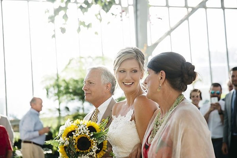 Bride with her father and mother, all three laughing, moments after the ceremony