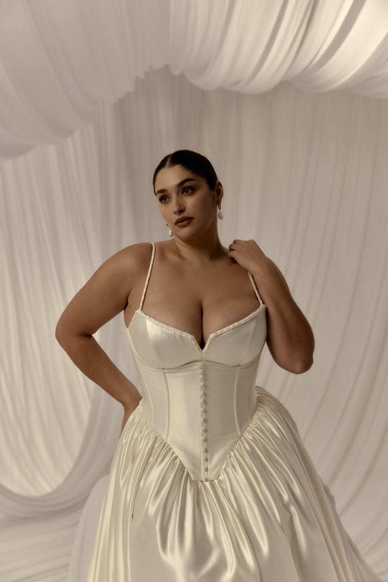 Hera Couture Lucille, a satin ballgown worn with the Fleur Corset, which ends in a deep V basque waist below the hips