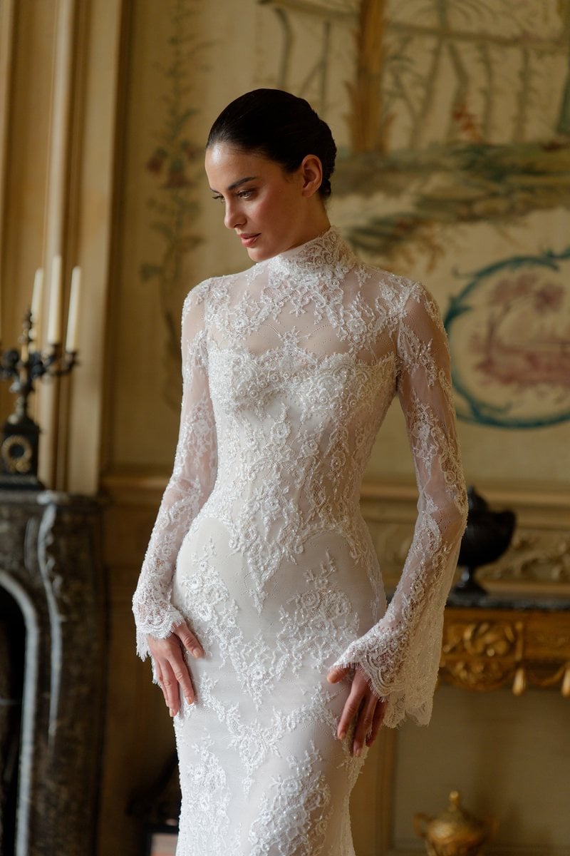 Lee Petra Grebenau Cadenza, a high-neck lace gown with long sheer lace sleeves