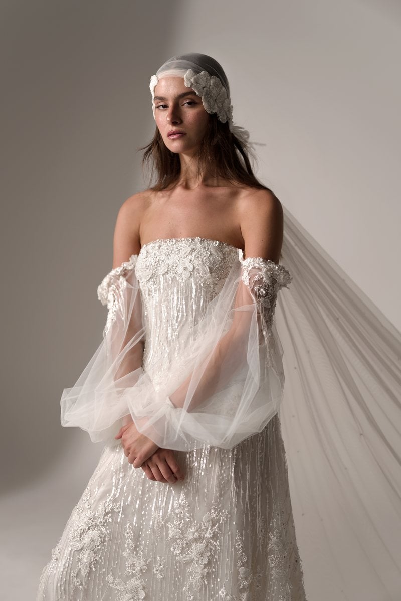 Dreams by Lihi Hod Ever, a beaded gown with sheer tulle sleeves and a Juliet cap veil