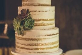 Naked wedding cake with succulents on a cake stand