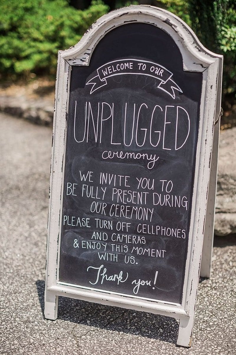 Chalkboard unplugged ceremony sign asking guests to turn off cellphones and cameras